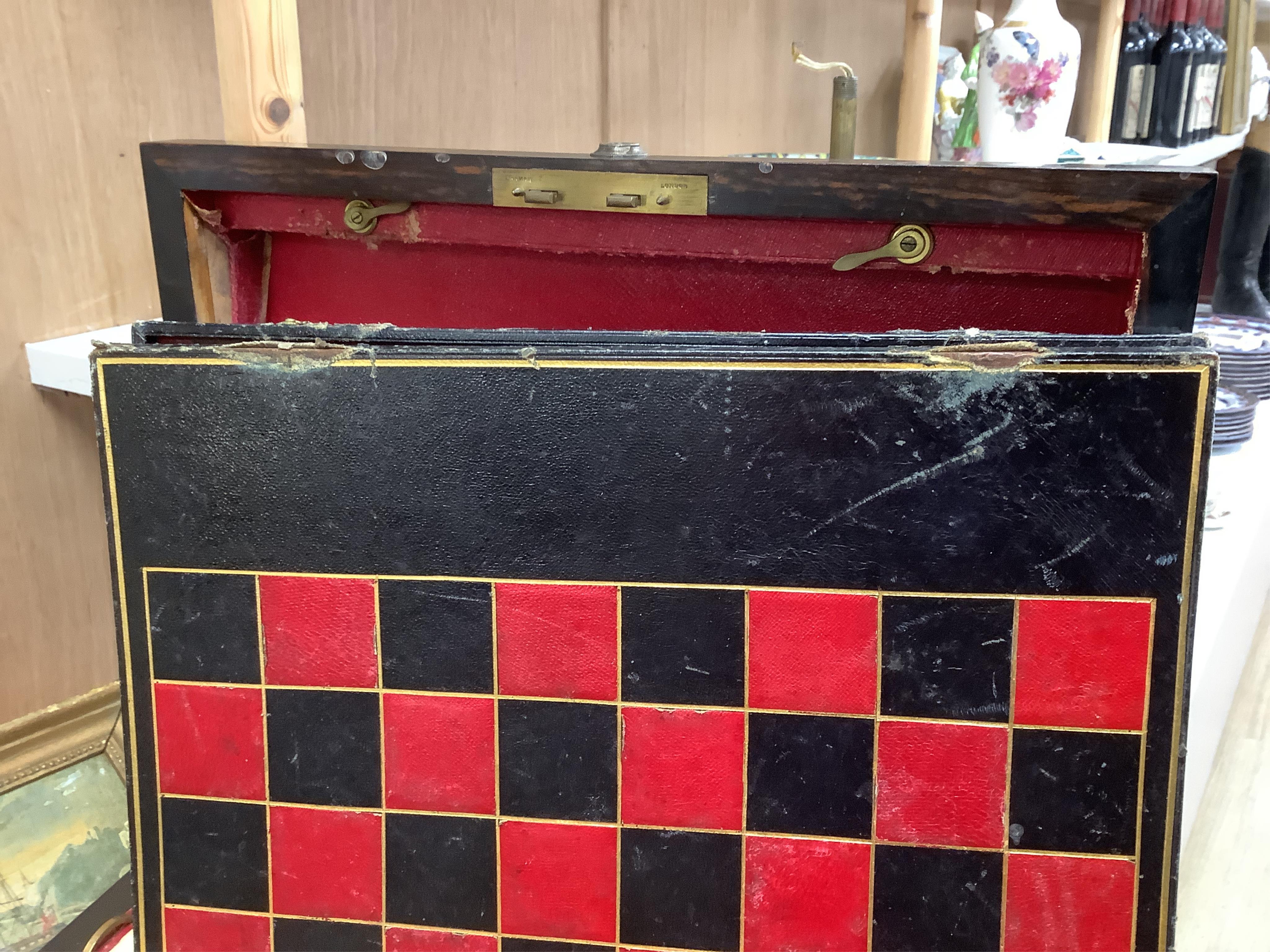 A Victorian coromandel games box with accessories, ivory chess pieces and counters, box 36cm wide x 19cm high. Condition - red interior leather worn and torn in places and box scratched, minor losses to chess pieces. CIT